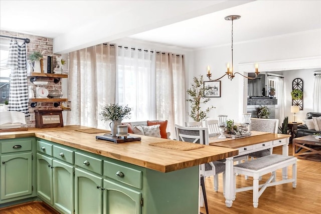 kitchen with light wood-style floors, plenty of natural light, and wooden counters