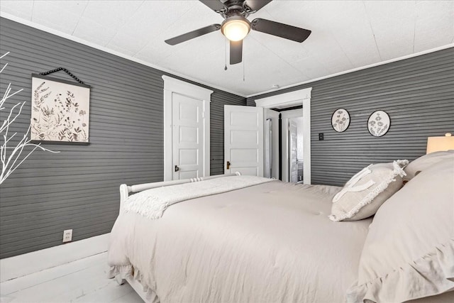 bedroom featuring ornamental molding and ceiling fan