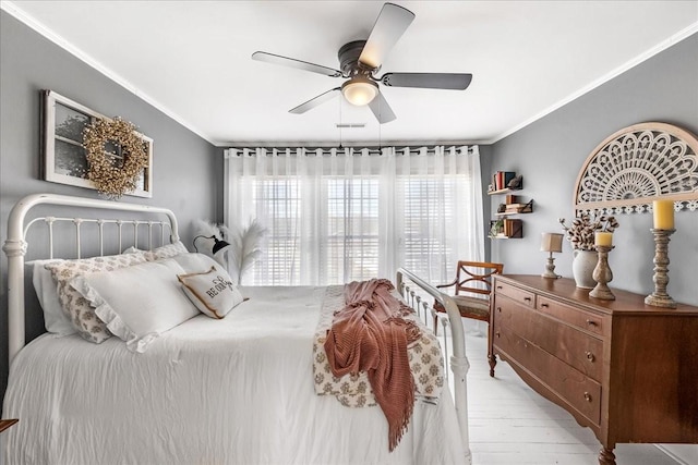 bedroom with light wood-type flooring, crown molding, and ceiling fan