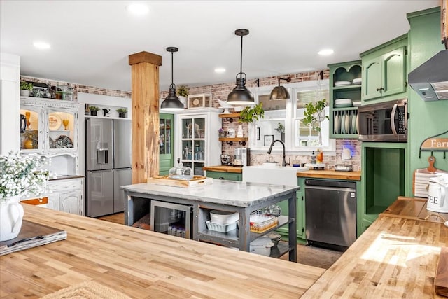 kitchen with wine cooler, butcher block countertops, stainless steel appliances, open shelves, and green cabinetry