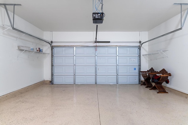 garage with baseboards and a garage door opener