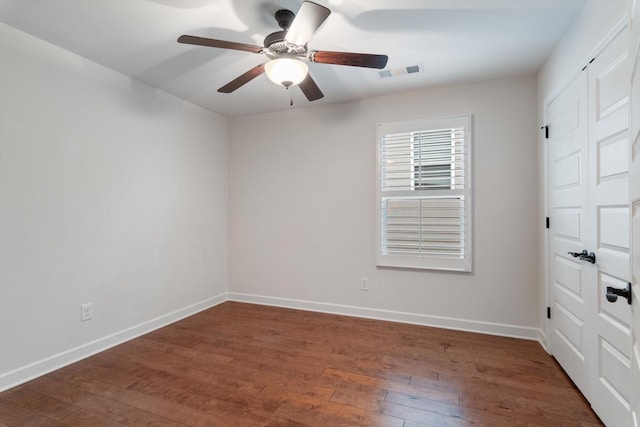 unfurnished room featuring ceiling fan, wood-type flooring, visible vents, and baseboards