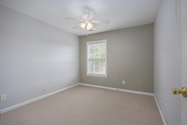 empty room with light carpet, a ceiling fan, and baseboards