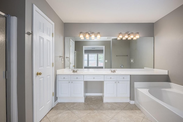 bathroom featuring tile patterned flooring, double vanity, a garden tub, and a sink