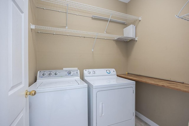 laundry area with washer and dryer, laundry area, and baseboards