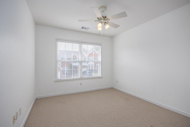 empty room with a ceiling fan, visible vents, carpet floors, and baseboards