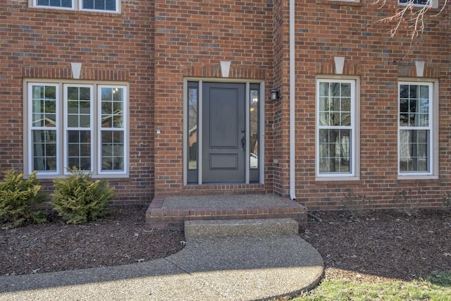 property entrance featuring brick siding