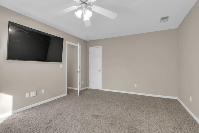 unfurnished room with a ceiling fan, carpet, visible vents, and baseboards