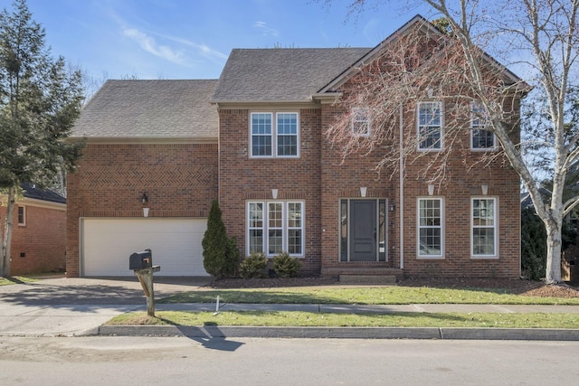 view of front of property with brick siding, a shingled roof, concrete driveway, a front yard, and a garage