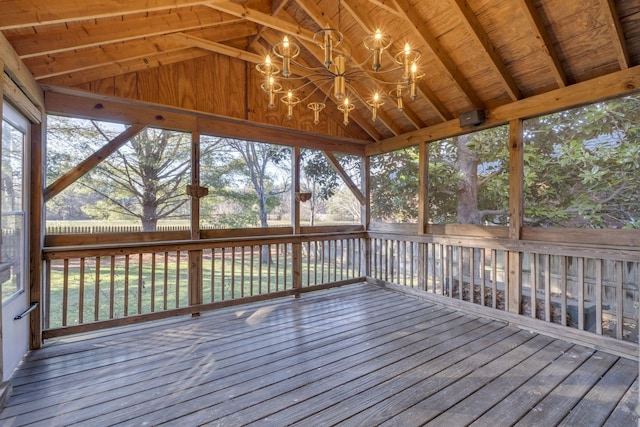 unfurnished sunroom featuring lofted ceiling with beams, wooden ceiling, and an inviting chandelier