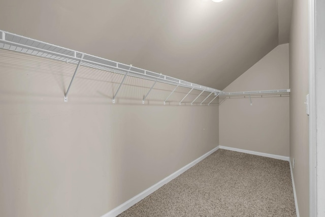 walk in closet with vaulted ceiling