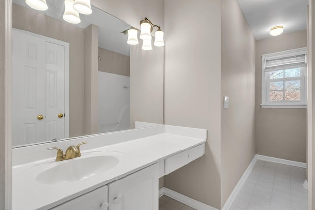 bathroom with baseboards, a shower, and vanity