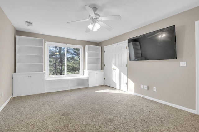 unfurnished room featuring ceiling fan, carpet flooring, visible vents, and baseboards