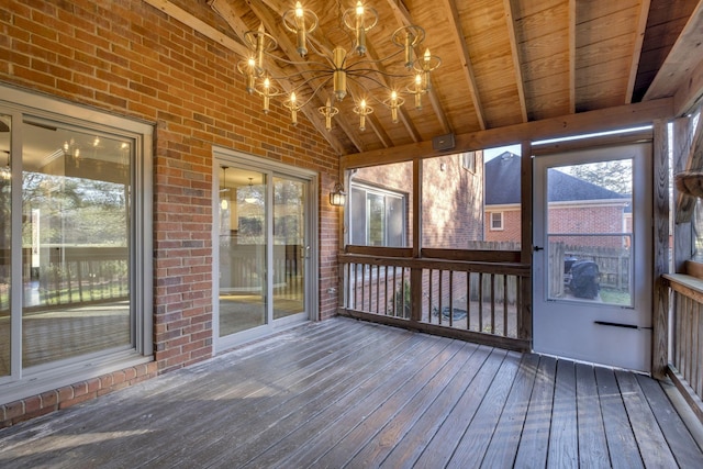 unfurnished sunroom featuring an inviting chandelier, wood ceiling, and vaulted ceiling