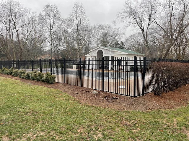 view of swimming pool with a covered pool, fence, a patio, and a lawn