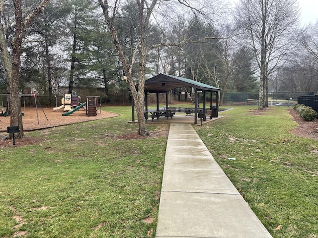 view of yard with a gazebo, playground community, and fence