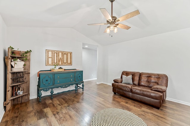 sitting room with lofted ceiling, wood finished floors, a ceiling fan, and baseboards