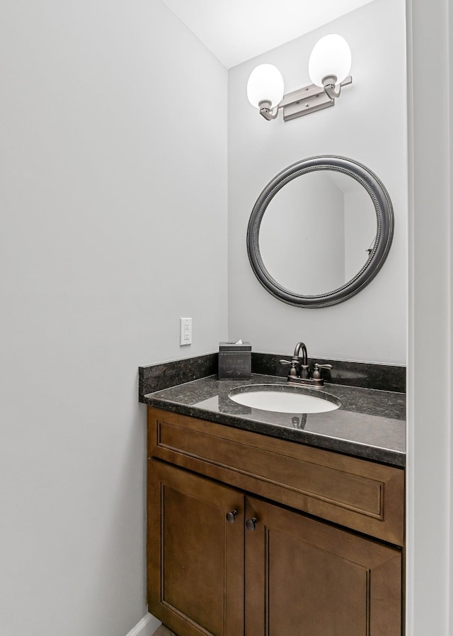 bathroom with vanity and baseboards