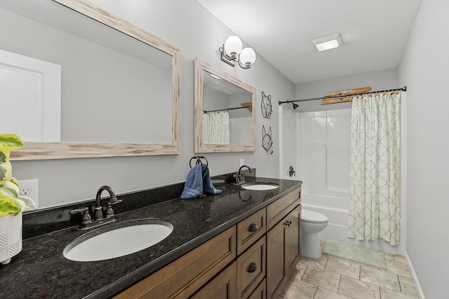 bathroom with double vanity, shower / bath combination with curtain, a sink, and toilet