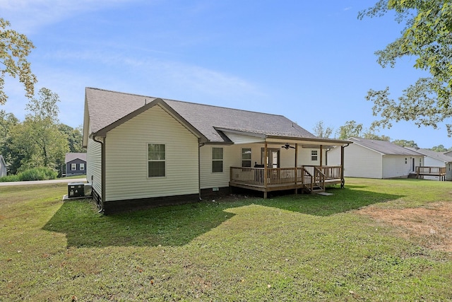 back of house featuring a deck, central air condition unit, a shingled roof, crawl space, and a lawn