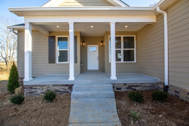 view of exterior entry featuring a porch