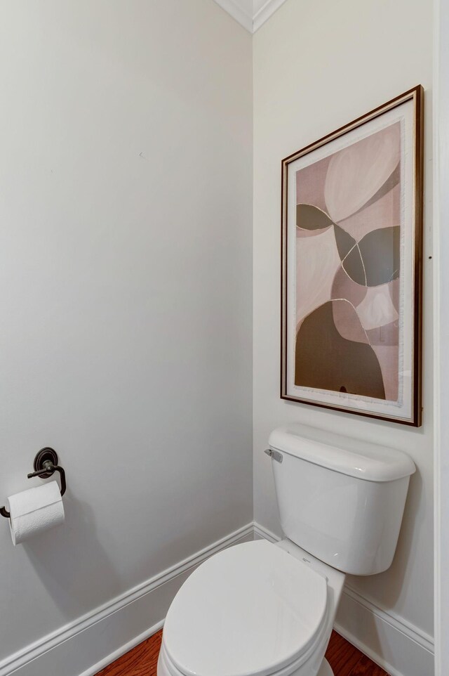 bathroom featuring baseboards, toilet, and wood finished floors