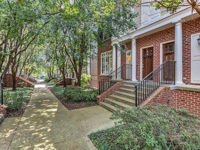 view of exterior entry featuring brick siding