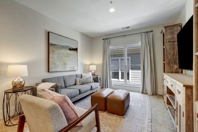 living area featuring recessed lighting, light carpet, visible vents, and baseboards