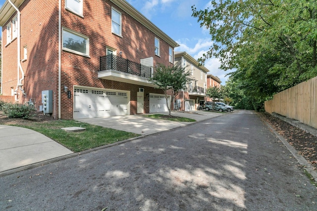 exterior space featuring brick siding, driveway, and an attached garage