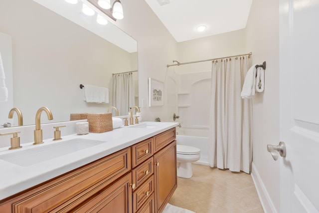 full bathroom with toilet, tile patterned flooring, double vanity, and a sink