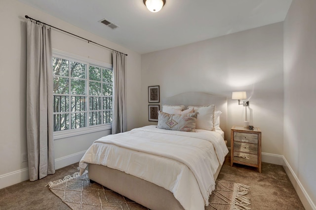 carpeted bedroom featuring visible vents and baseboards