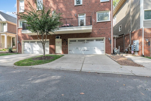 view of front of home with brick siding, driveway, and an attached garage