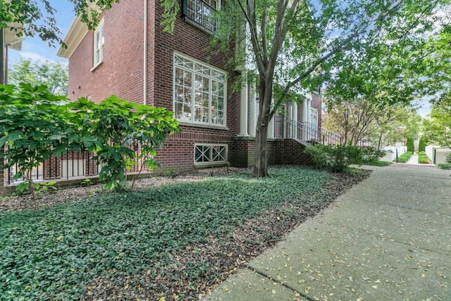 view of side of property featuring brick siding