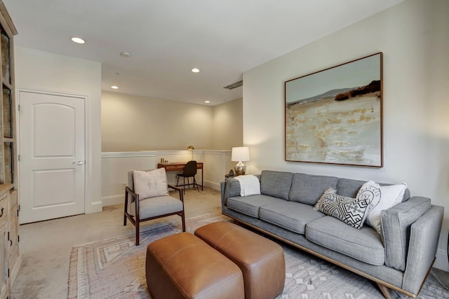 living room with recessed lighting, light colored carpet, visible vents, and baseboards