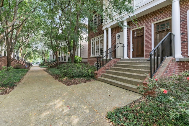 doorway to property with brick siding