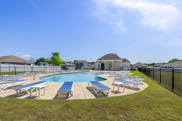 pool featuring a patio, a yard, fence, and a residential view