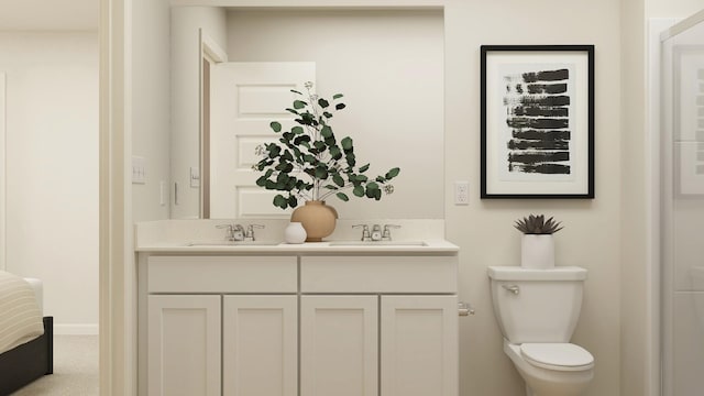 bathroom featuring baseboards, a sink, toilet, and double vanity