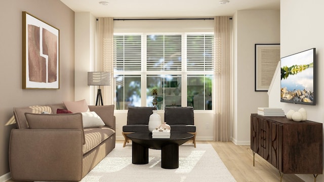 sitting room with baseboards and wood finished floors