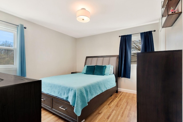 bedroom featuring light wood-style flooring and baseboards