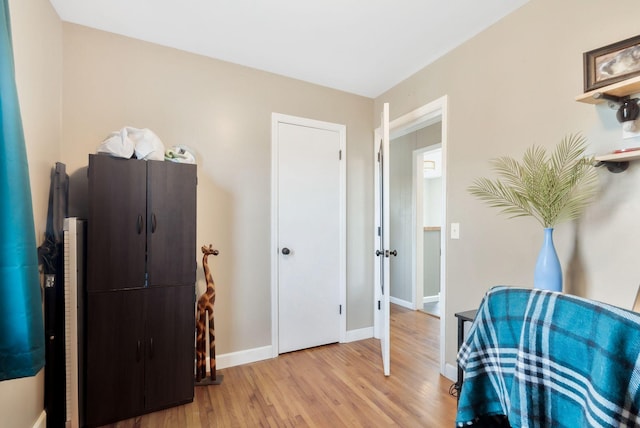 sitting room with light wood-type flooring and baseboards