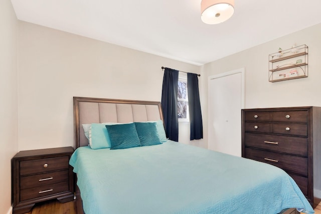 bedroom with dark wood-style floors