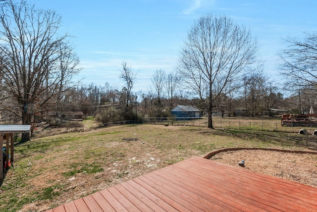 wooden terrace with fence and a yard