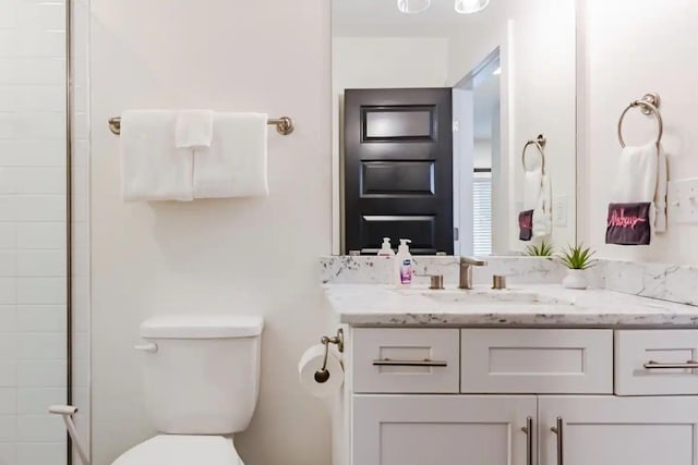 full bathroom with vanity and toilet