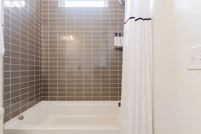 bathroom with shower / bath combo with shower curtain