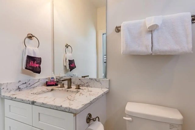 bathroom featuring vanity and toilet