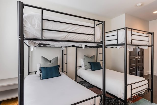 bedroom with wood finished floors and recessed lighting