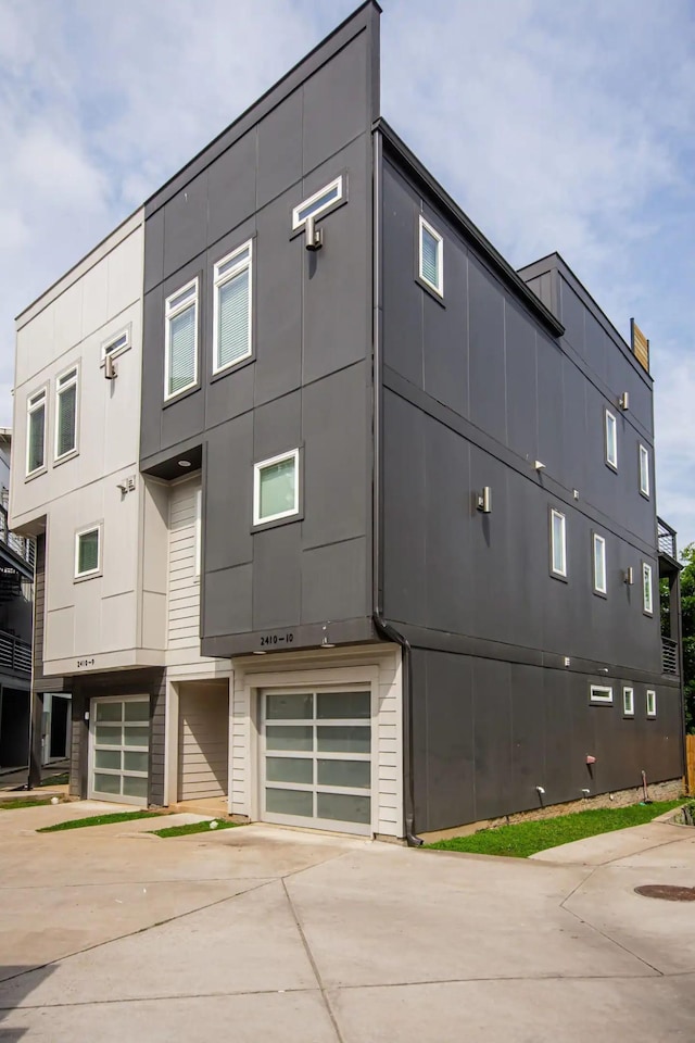 view of property featuring a garage and driveway