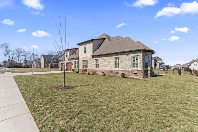 view of property exterior with a yard, brick siding, crawl space, and a residential view