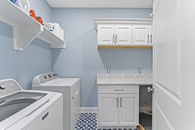 clothes washing area featuring cabinet space, baseboards, and washer and dryer