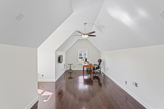 additional living space with wood finished floors, a ceiling fan, visible vents, vaulted ceiling, and baseboards